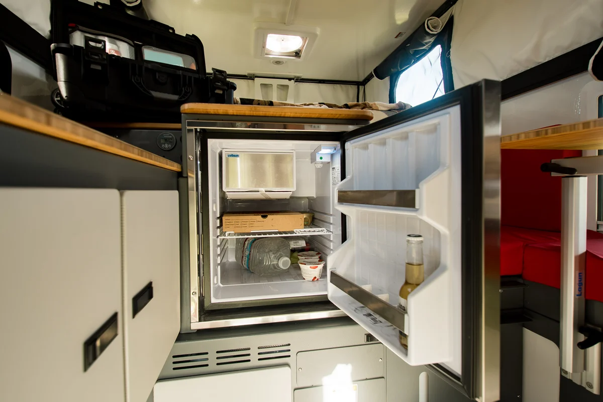Back Country 6.85 Dometic compressor fridge open close-up with contents visible on bamboo-trimmed interior