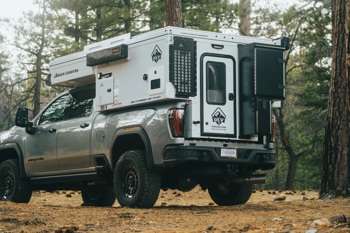 Back Country 6.85 driver-side rear three-quarter closer shot with Back Country and OEV badges visible