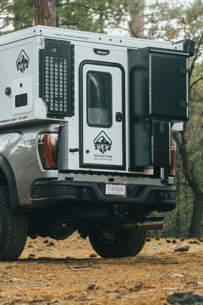 Back Country 6.85 rear close-up showing entry door, MOLLE panel, and 'Built to Conquer' text