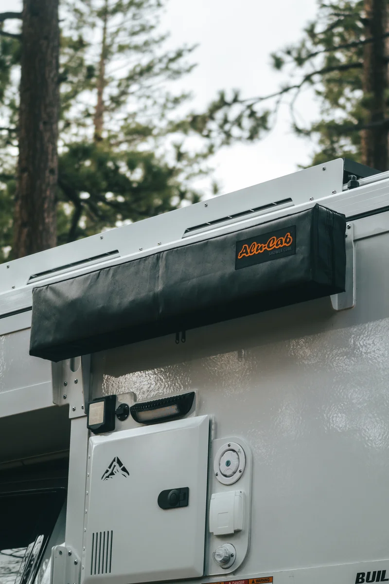 Back Country 6.85 close-up of Alu-Cab awning bracket and Truma Aquago hot water heater access panel