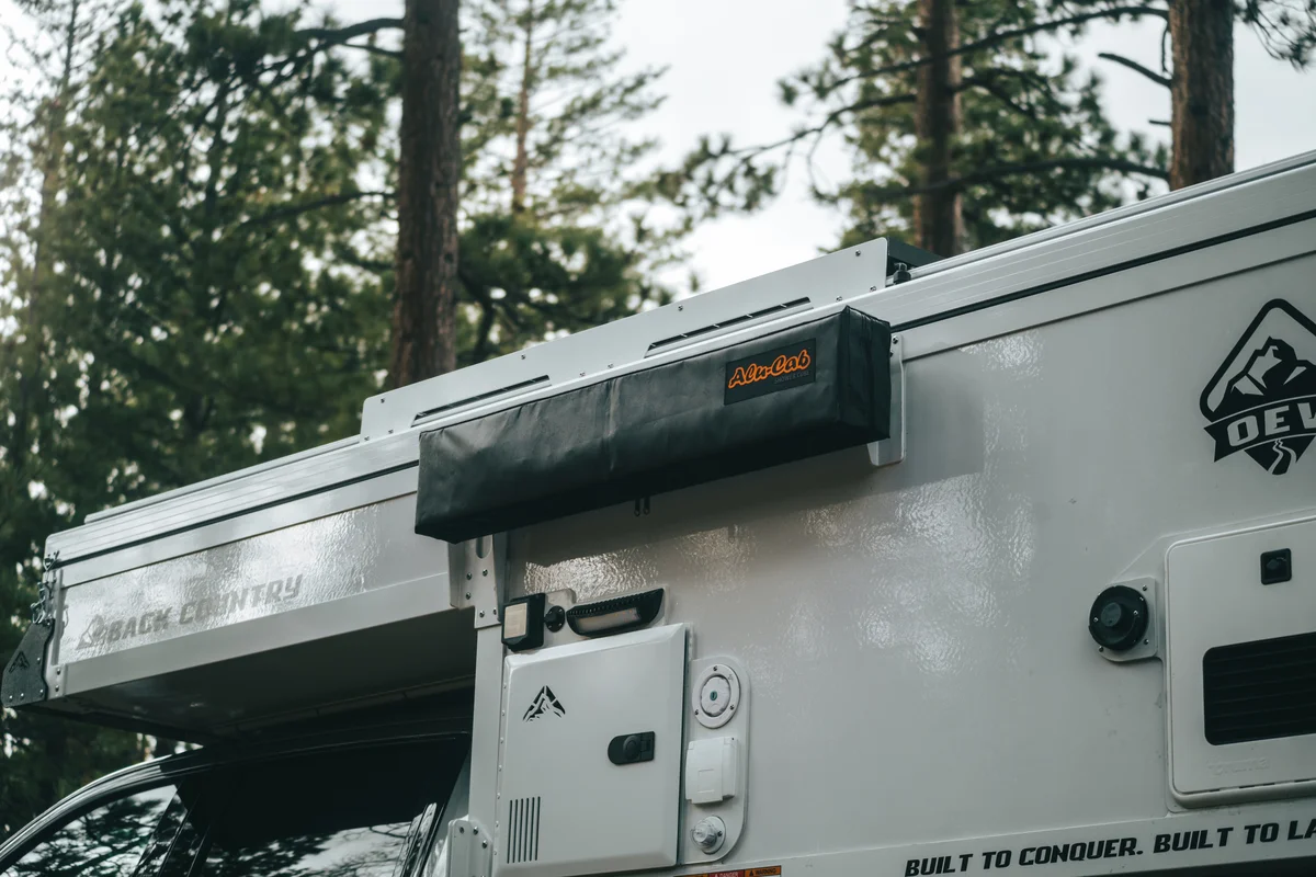 Back Country 6.85 Alu-Cab awning and Truma heater panel wider view with Back Country badge