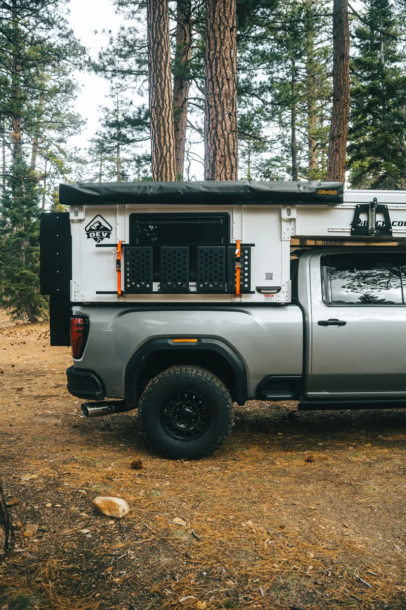 Back Country 6.85 passenger side wider portrait showing Alu-Cab awning and MOLLE steps