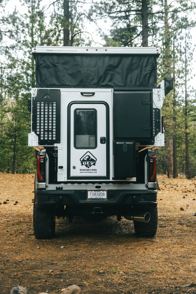 Back Country 6.85 rear three-quarter close-up portrait with pop-up open, entry door, and passenger storage box