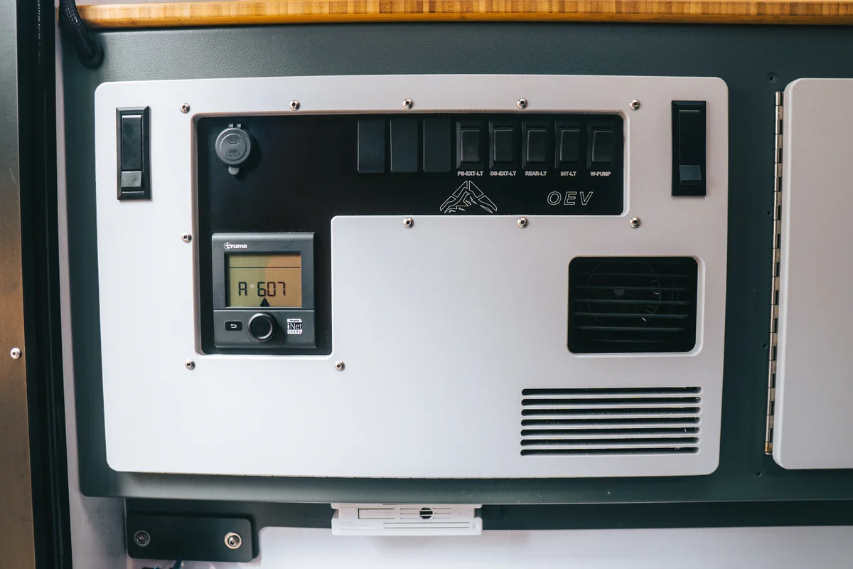 Back Country 6.85 OEV electrical control panel showing Truma thermostat, rocker switch panel, and Truma Vario heater grille